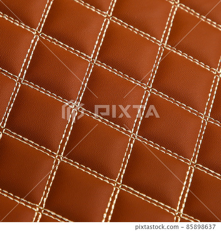 Texture of brown leather background with square pattern and stitch, macro 85898637