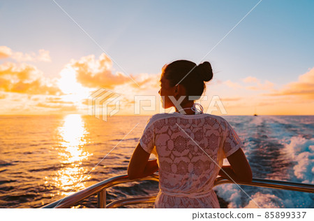 Cruise ship vacation woman watching sunset boat deck on summer travel. Silhouette of tourist relaxing on outdoor balcony of boat ferry 85899337