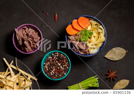 Lagman with turkey . Top view on a black background with cooking ingredients. Lagman with turkey . Top view on a black background with cooking ingredients. 85901136
