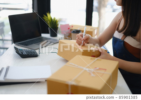 Asian small business owner working at home office. Business retail market and online sell marketing delivery, SME e-commerce concept. Asian small business owner working at home office. Business retail market and online sell marketing delivery, SME e-commerce concept. 85901385