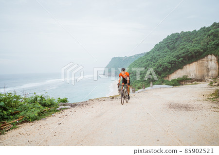 road bike cyclist riding his bike on a cliff road bike cyclist riding his bike on a cliff 85902521