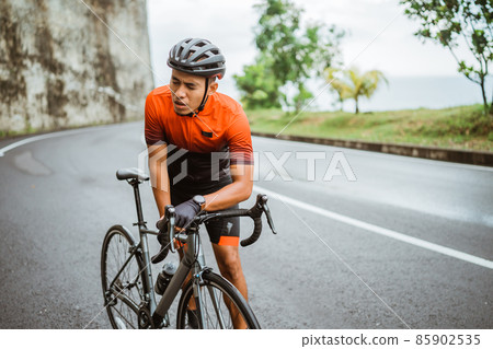 tired cyclist while riding his bike outdoor 85902535