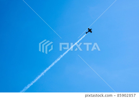 Overhead flying aircraft. Aircraft in formation during an aerobatics display as they loop and roll through the sky. Plane engine failure. Falling airplane crashes 85902857
