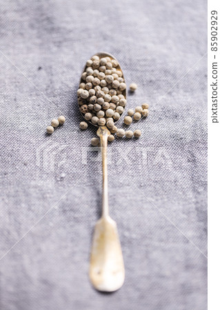 Whole pepper spice. White peppercorn grain in spoon Whole pepper spice. White peppercorn grain in spoon 85902929