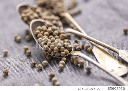 Whole pepper spice. White peppercorn grain in spoon Whole pepper spice. White peppercorn grain in spoon 85902930