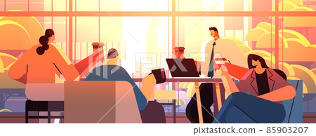 mix race businesspeople sitting at cafe table and drinking coffee during meeting modern cafeteria interior mix race businesspeople sitting at cafe table and drinking coffee during meeting modern cafeteria interior 85903207