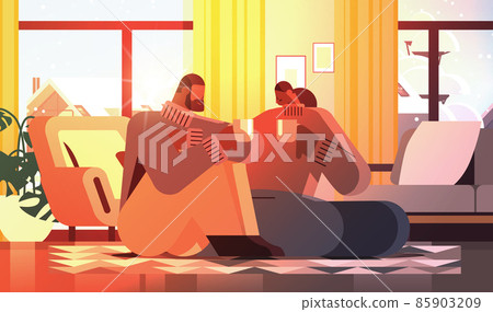 african american couple drinking coffee and talking together at home living room interior horizontal african american couple drinking coffee and talking together at home living room interior horizontal 85903209
