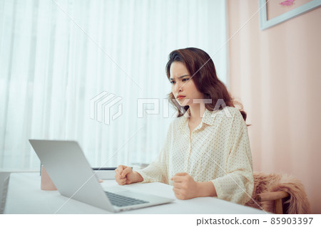 Angry Woman Going Crazy for Tragedy while Working on Laptop Angry Woman Going Crazy for Tragedy while Working on Laptop 85903397