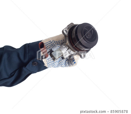 An auto mechanic holds a faulty car cooling system pump that drives coolant, white background, isolate. Regulations for replacing the auto pump 85905878