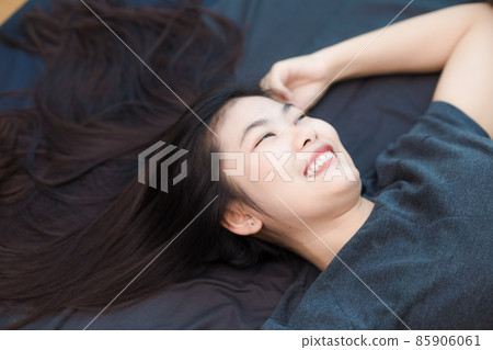 Beautiful asian long hair women lying on bed Beautiful asian long hair women lying on bed 85906061