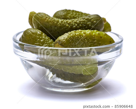 Bowl of Tasty canned Whole green cornichons isolated on a white background Bowl of Tasty canned Whole green cornichons isolated on a white background 85906648