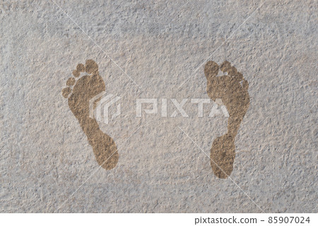 closeup of child wet foot prints on stone closeup of child wet foot prints on stone 85907024