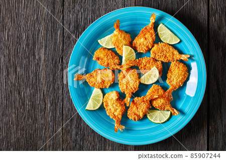 Crispy Fried Butterfly Shrimp on a blue plate Crispy Fried Butterfly Shrimp on a blue plate 85907244