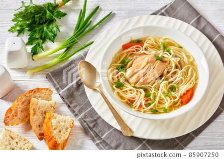 chicken noodle soup with carrots and scallion 85907250