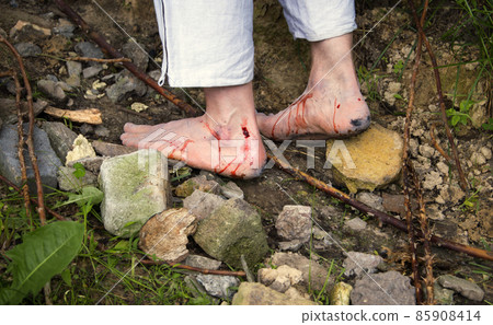 Wounded feet walk a hard rocky path Wounded feet walk a hard rocky path 85908414