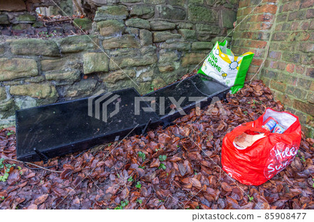 Fly-tipped televisions and bags of grocery rubbish, Manchester, UK. 85908477