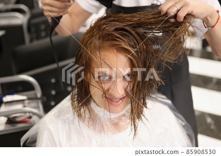 Hairdresser using hairdryer for treatment with hair, dry wet hair after beauty procedure Hairdresser using hairdryer for treatment with hair, dry wet hair after beauty procedure 85908530