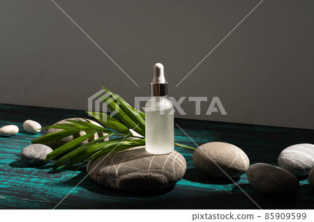 Layout for your cosmetics or product with natural stones background made of environmentally friendly materials. The concept of an ecological lifestyle, a layout for the sale of serum, for your product 85909599