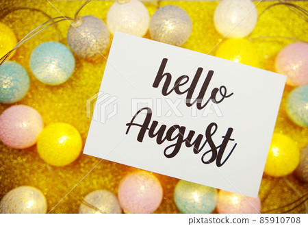 Hello August text on paper card with LED cotton balls decorate on yellow background Hello August text on paper card with LED cotton balls decorate on yellow background 85910708