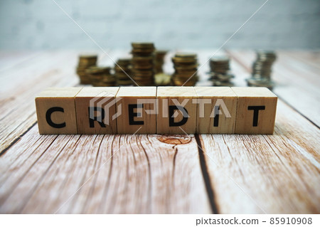 Credit alphabet letter and coins on wooden background 85910908