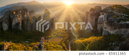 Mountain monastery and rocks in Meteora at sunset. Greece. Mountain monastery and rocks in Meteora at sunset. Greece. 85911365