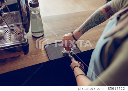 Young woman hands making coffee in cafeteria Young woman hands making coffee in cafeteria 85912522