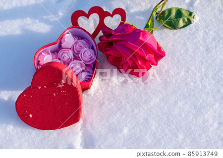 Gift with a rose and a box of sweets in the snow beloved Gift with a rose and a box of sweets in the snow beloved 85913749
