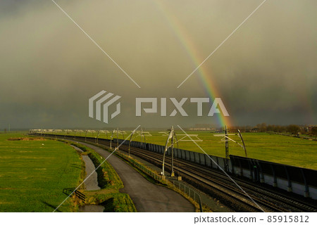 Rainbow above an empty railroad track near Sliedrecht 85915812