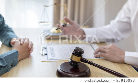 Attorney or judge provides legal advice to the client in the courtroom, Ethics in the courts include justice and impartiality, legal consultant, scales of justice, law hammer, Litigation and justice. 85916058