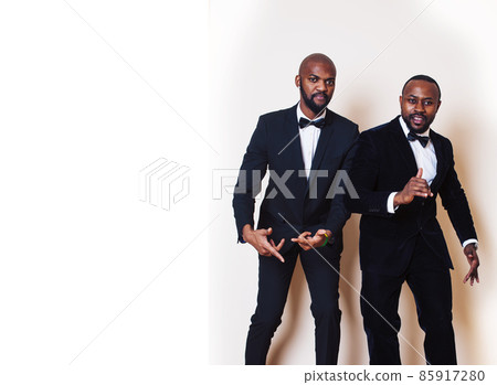two african-american businessmen in black suits emotional posing, gesturing, smiling. wearing bow-ties two african-american businessmen in black suits emotional posing, gesturing, smiling. wearing bow-ties 85917280