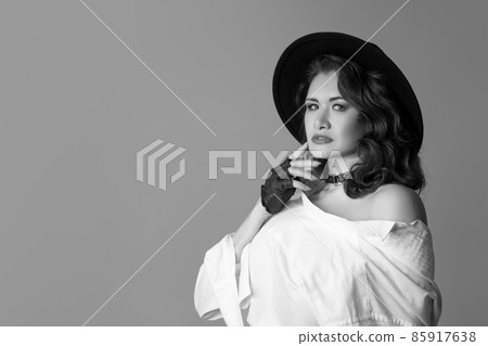 Half-length monochrome portrait of young beautiful woman posing isolated on gray studio background. Beauty, fashion, style, bodypositive concept 85917638