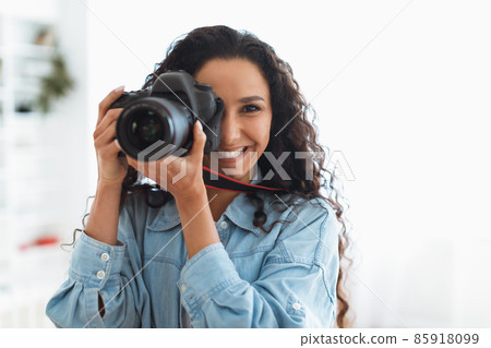 Happy Photographer Lady Taking Photo Holding Camera Near Face Indoors 85918099