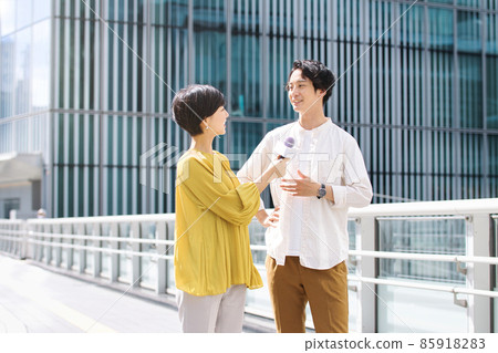 A man receiving a street interview A man receiving a street interview 85918283