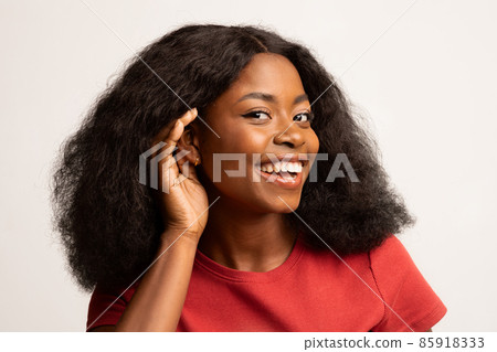 Curious Cheerful Black Woman With Hand Near Ear Trying To Overhear Something 85918333