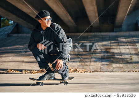 Skater male with skateboard on street urban background 85918520