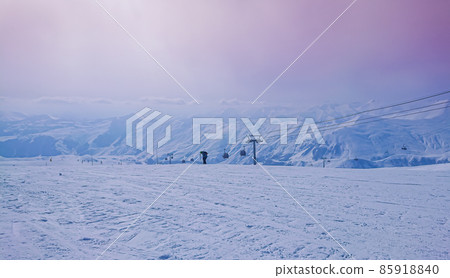 Majestic snowy peaks landscape and pink sky in sunset rays of sun Majestic snowy peaks landscape and pink sky in sunset rays of sun 85918840