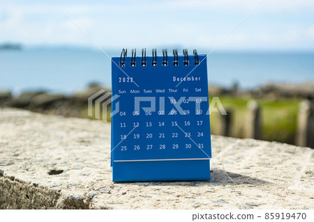 Blue December 2022 calendar on blurred background of blue ocean Blue December 2022 calendar on blurred background of blue ocean 85919470