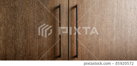 Modern minimalistic kitchen with black and wooden surfaces, marble kitchen island top and household appliances. Modern Concept For Interior Design And Architecture. 85920572