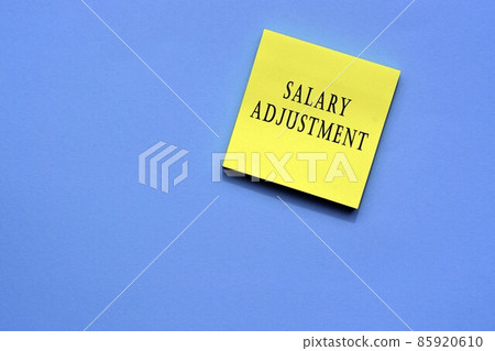 Salary adjustment text on yellow sticky note with blue background Salary adjustment text on yellow sticky note with blue background 85920610