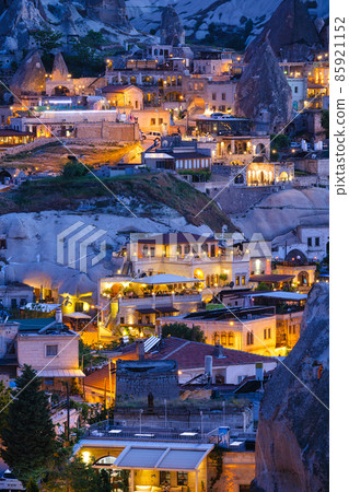 Goreme, Cappadocia, Turkey. View of the evening city from the mountain. Bright evening city. Goreme, Cappadocia, Turkey. View of the evening city from the mountain. Bright evening city. 85921152