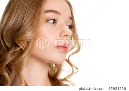 Close-up portrait of young beautiful girl with day makeup isolated over white studio background. Natural beauty concept. Close-up portrait of young beautiful girl with day makeup isolated over white studio background. Natural beauty concept. 85921236