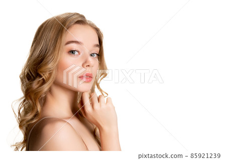 Close-up portrait of young beautiful girl with day makeup isolated over white studio background. Natural beauty concept. Close-up portrait of young beautiful girl with day makeup isolated over white studio background. Natural beauty concept. 85921239