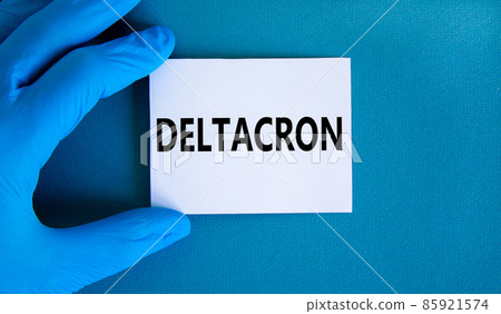 Covid-19 corona deltacron variant symbol. Hand in blue glove with white card. The concept word Deltacron. Medical and COVID-19 corona deltacron variant concept. Copy space. 85921574