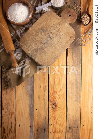 Cutting board and scattered flour powder on wood background top table Cutting board and scattered flour powder on wood background top table 85921613