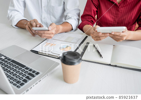 Teamwork of business casual colleagues, consultation new strategy plan business and market growth on financial document graph report, conference to making growth profit, Partner meetings and briefing 85921637