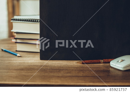 Chalkboard and school supplies on table. Student home workplace 85921737