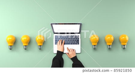 Person using a laptop computer with light bulbs 85921850