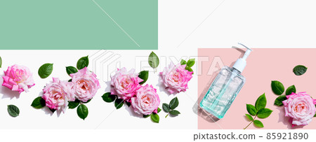 Sanitizer bottle with pink roses overhead view Sanitizer bottle with pink roses overhead view 85921890
