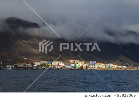 View of the Arctic port town at the foot of the mountain on the coast of the bay 85922069