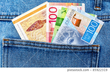 Danish, Norwegian and Swedish kroner protrude from the pocket of jeans 85922319